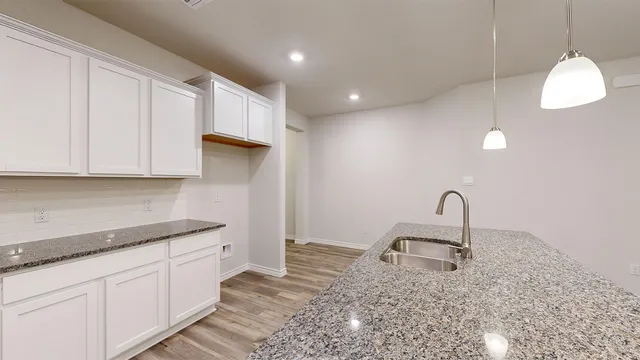 a kitchen with kitchen island granite countertop stainless steel appliances sink and cabinets
