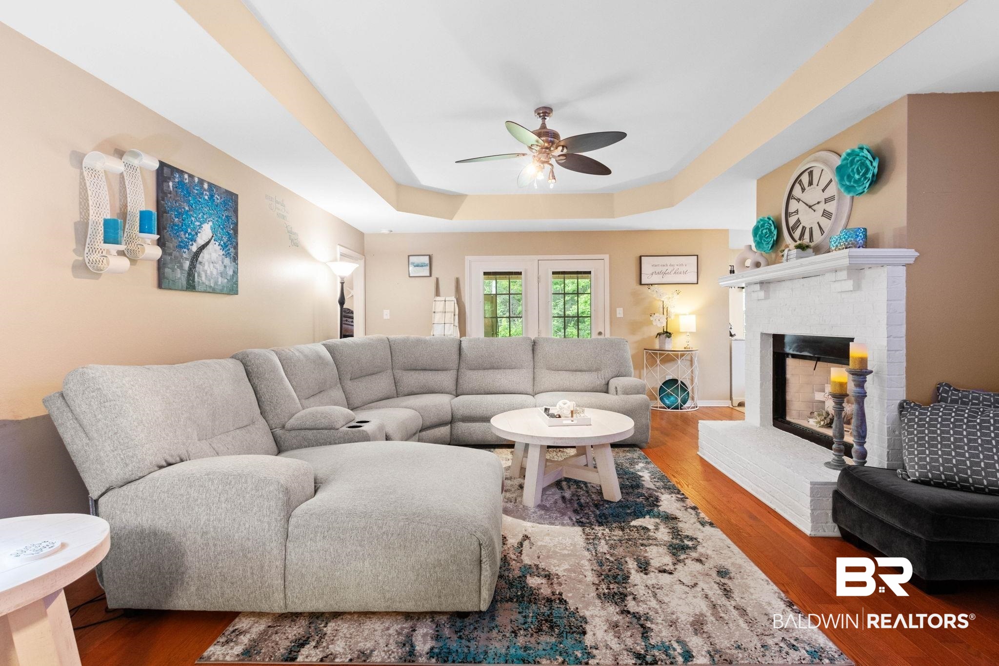 16151 Tolbert Road Bay Minette, AL 36507 - Photo 5 of 74 Living area featuring rich wood-finish flooring, a white brick fireplace with a mantel, and double French doors