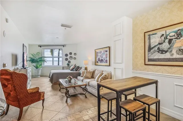 a living room with furniture a rug and a window