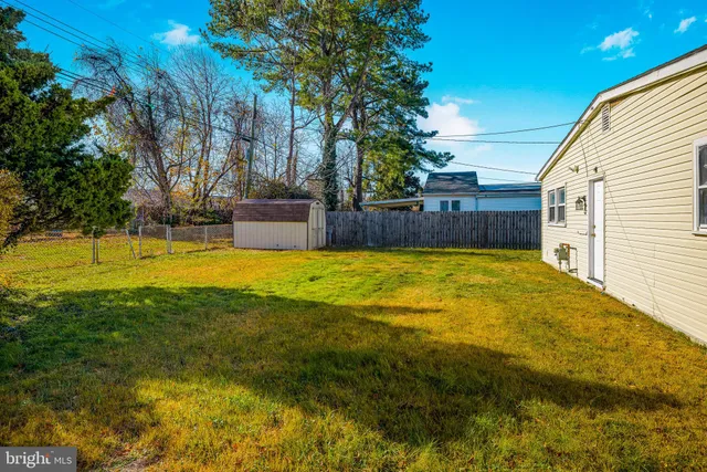 a view of house with yard and sitting area