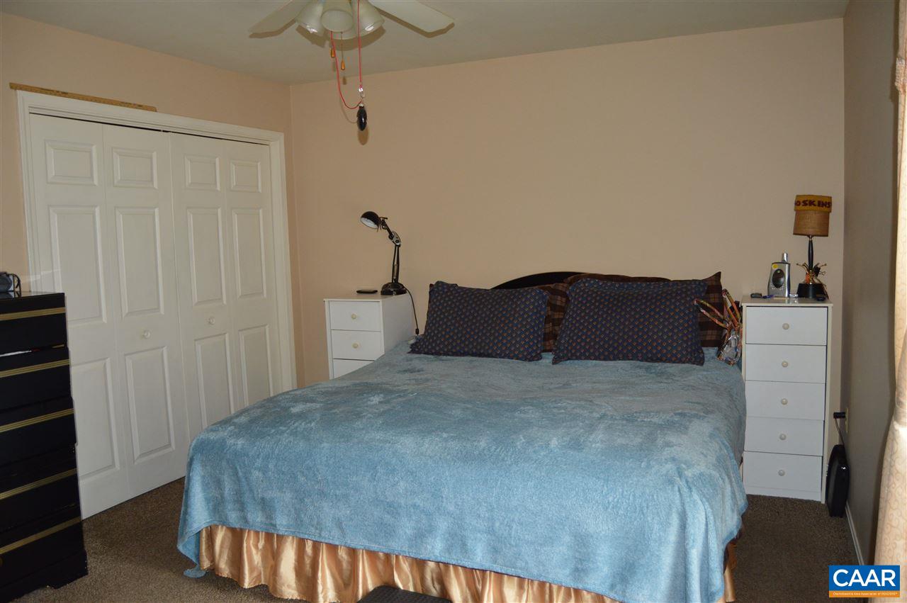 92 Rippin Run Road Ruckersville, VA 22968 - Photo 11 of 17 a bedroom with a bed and a cabinets