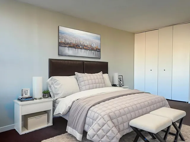 a bedroom with a bed and a table in it