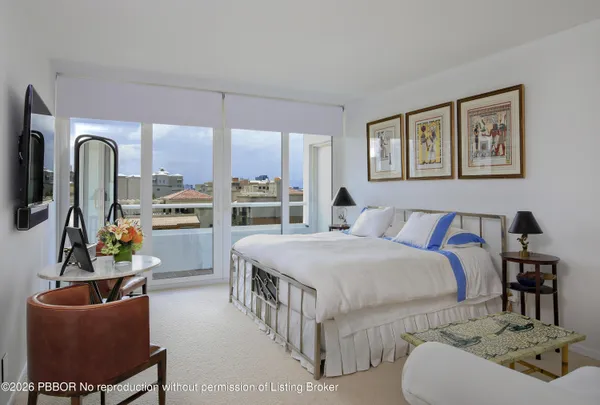 a large white bed in a white room