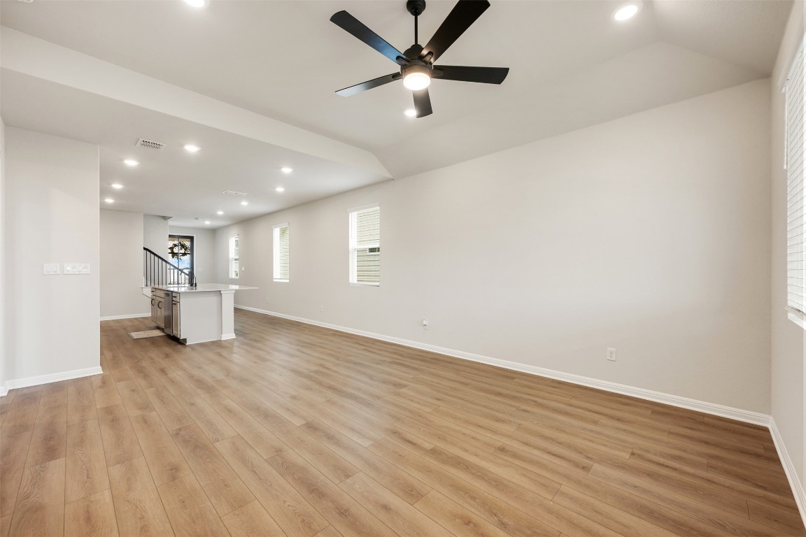 283 Ranier Way Dripping Springs, TX 78620 - Photo 16 of 39 Unfurnished living room featuring recessed lighting, light wood-type flooring, vaulted ceiling, and a ceiling fan