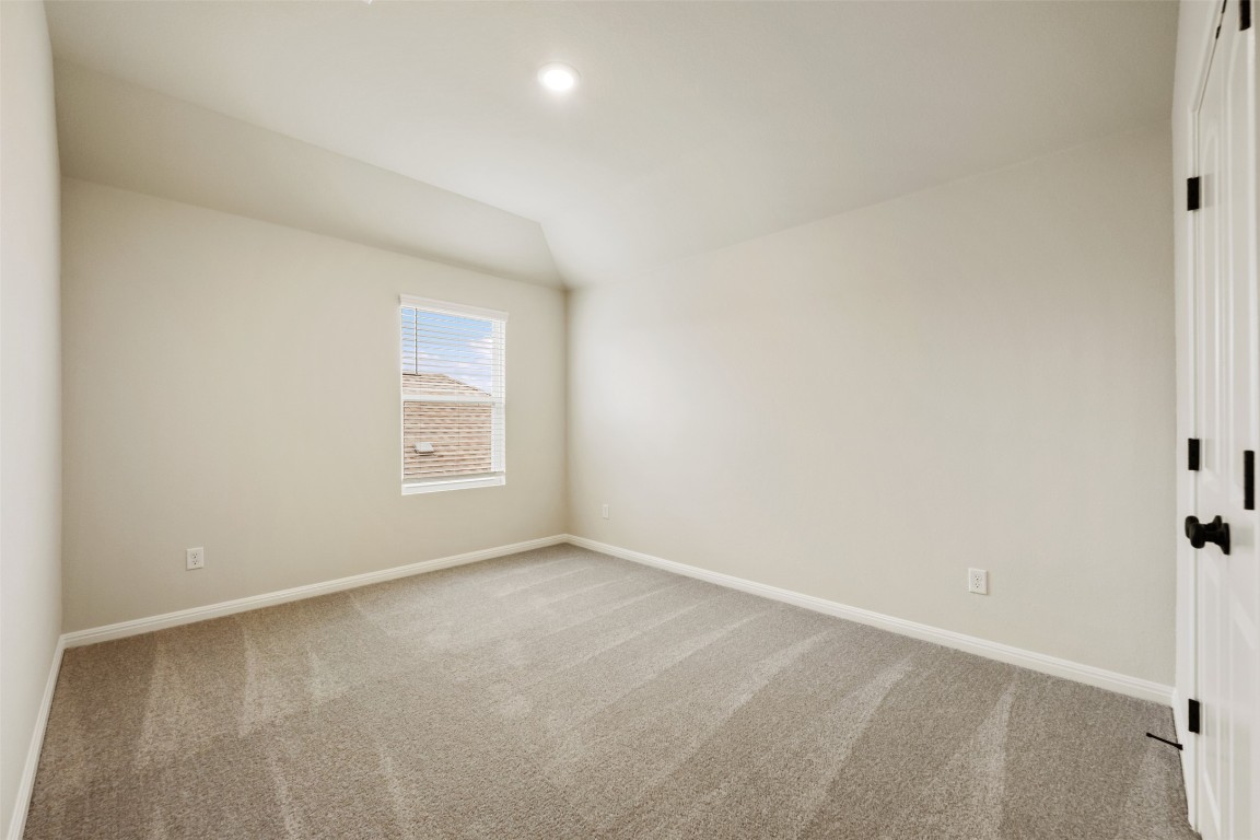283 Ranier Way Dripping Springs, TX 78620 - Photo 32 of 39 Carpeted spare room with vaulted ceiling and recessed lighting