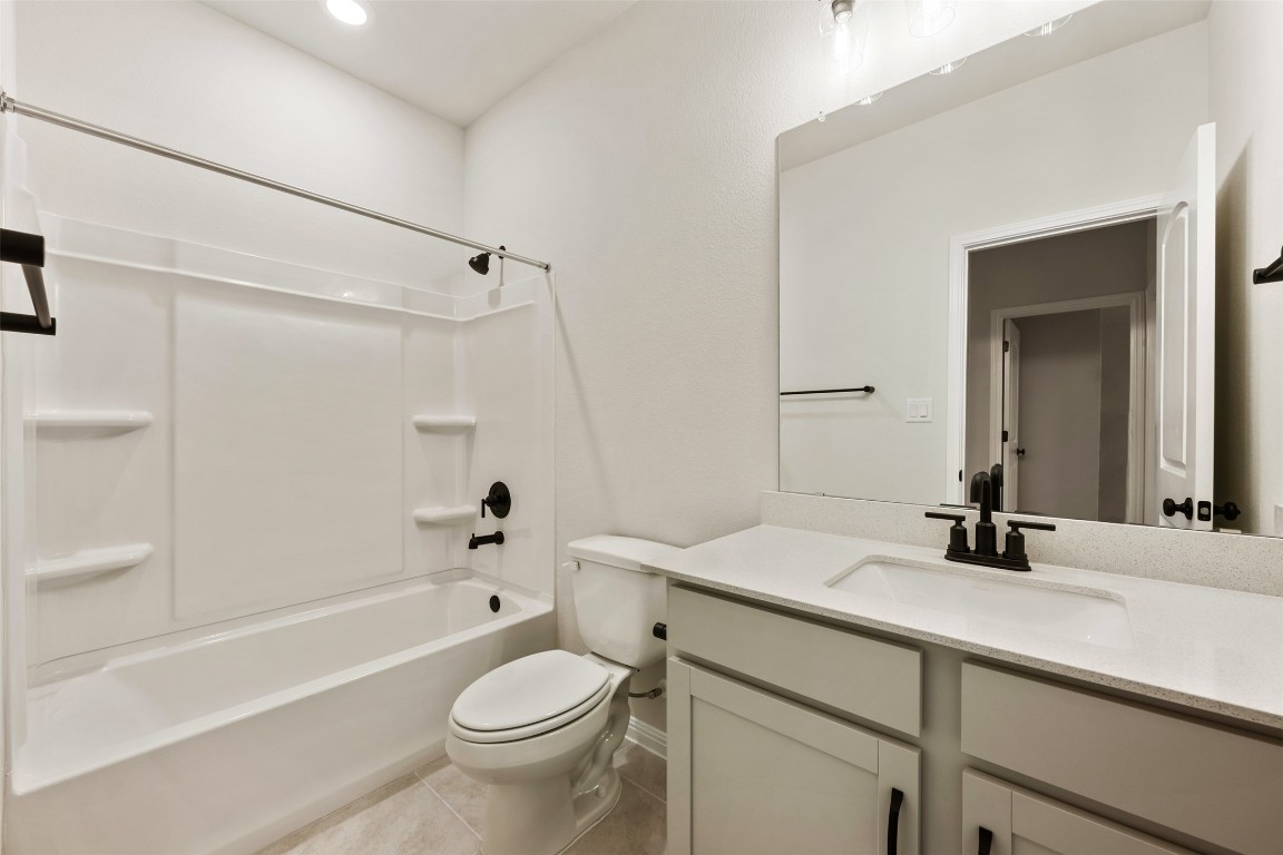 283 Ranier Way Dripping Springs, TX 78620 - Photo 34 of 39 Full bathroom featuring tub / shower combination, vanity, and light tile patterned floors
