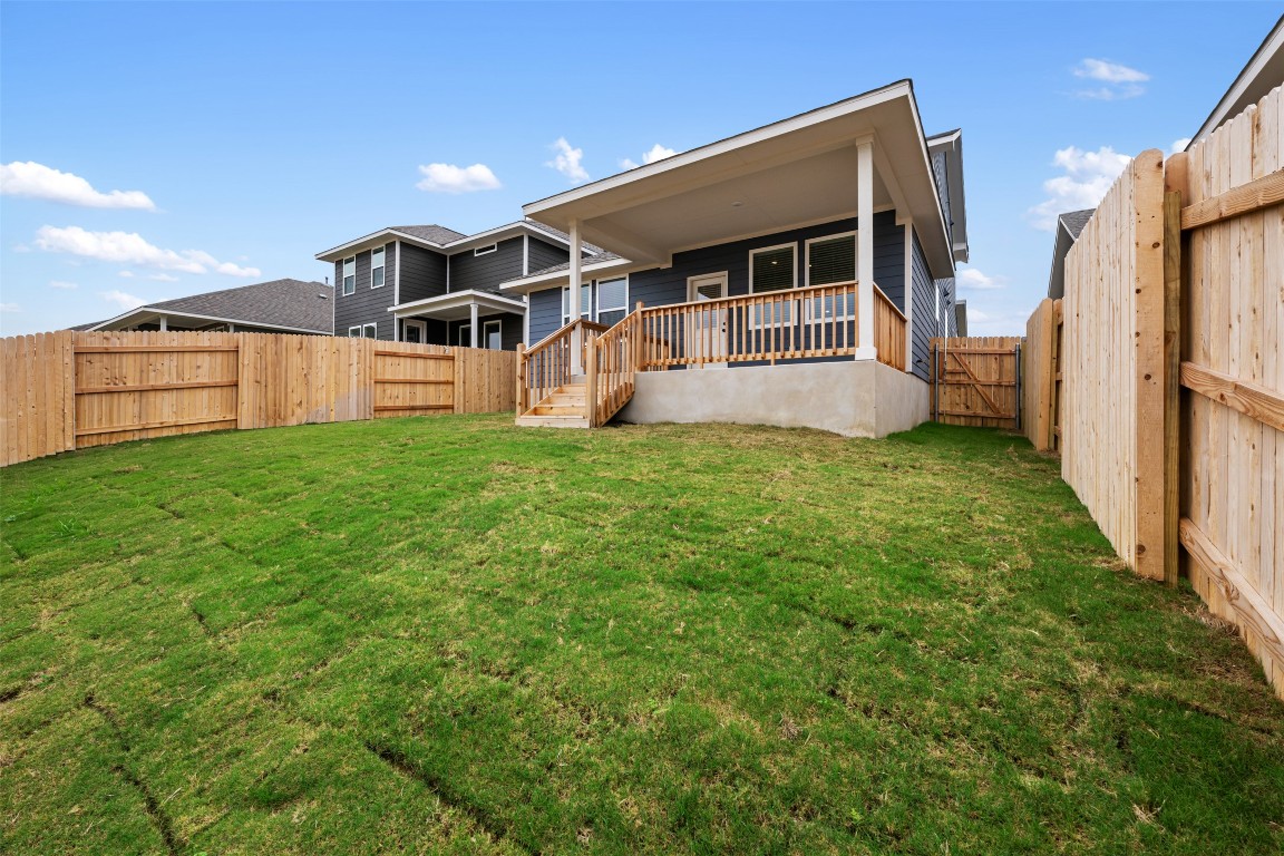 283 Ranier Way Dripping Springs, TX 78620 - Photo 36 of 39 Rear view of property with a fenced backyard, a gate, and a wooden deck
