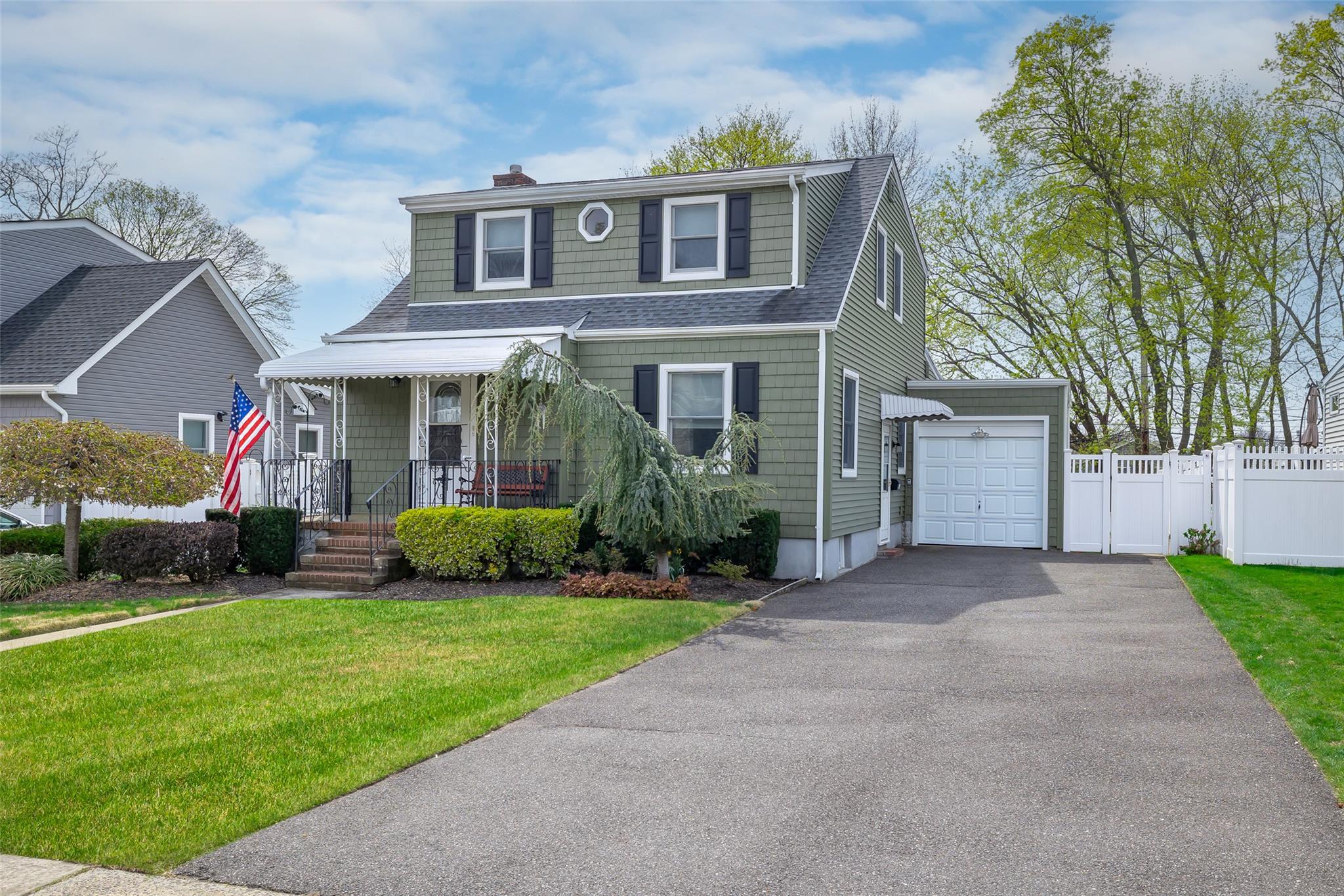 44 Jefferson Road Farmingdale, NY 11735 - Photo 1 of 1 View of front of property featuring a chimney, fence, aphalt driveway, a shingled roof, and a front lawn