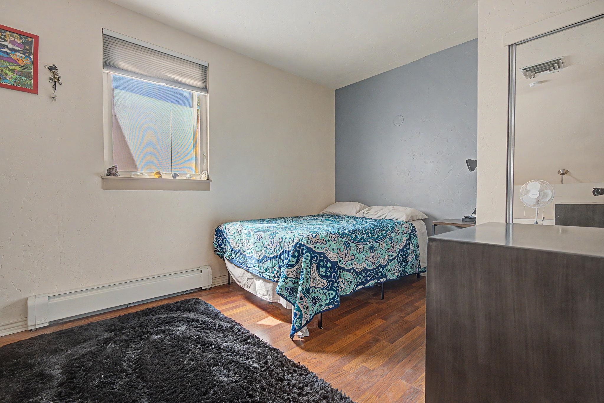 948 Northern Way, Unit 4 Grand Junction, CO 81506 - Photo 7 of 14 a bedroom with a bed and a window