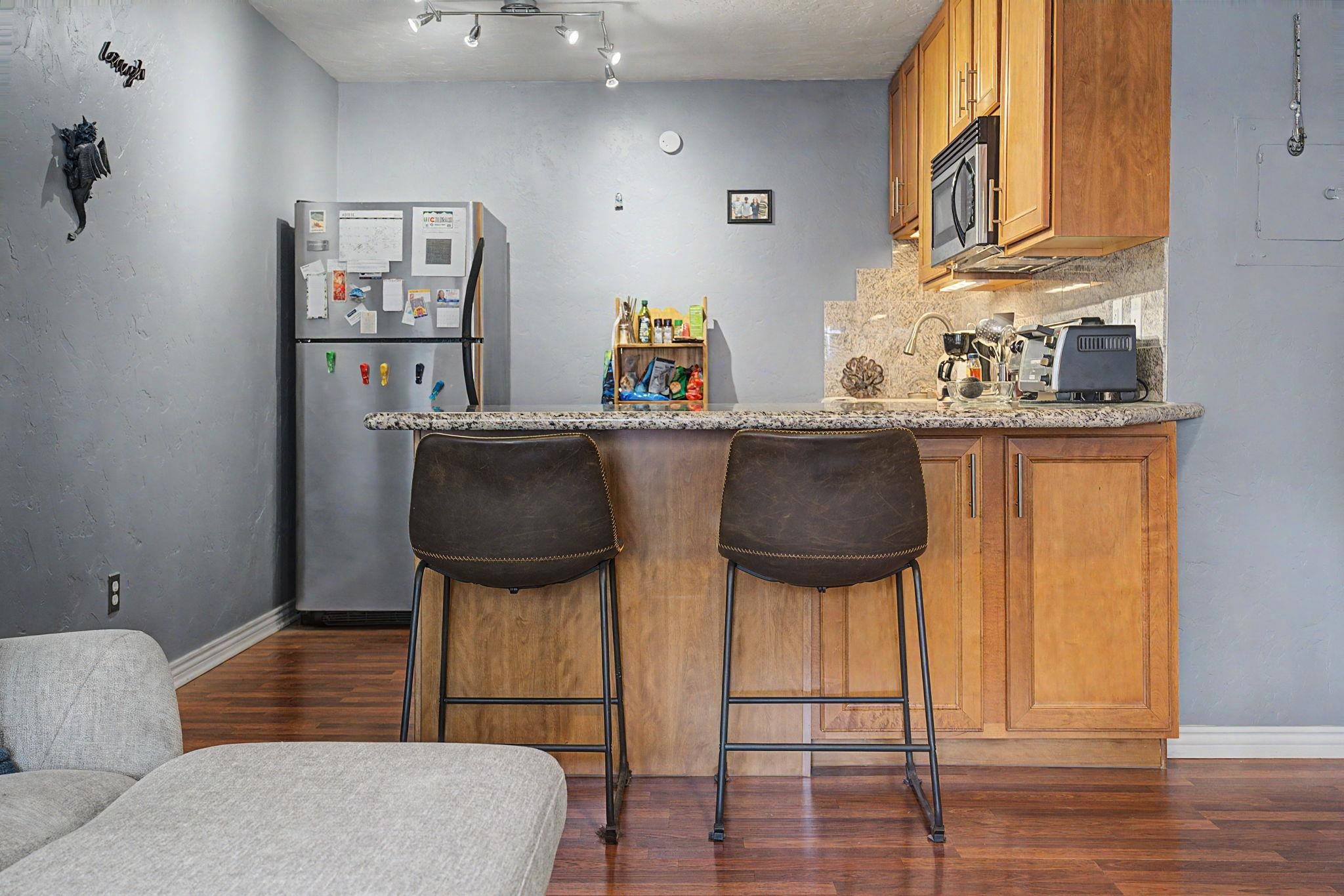 948 Northern Way, Unit 4 Grand Junction, CO 81506 - Photo 9 of 14 a living room with stainless steel appliances furniture a rug and a chandelier