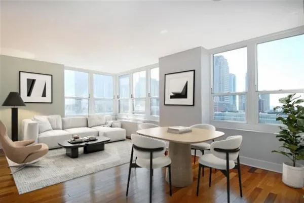 a living room with furniture and a potted plant