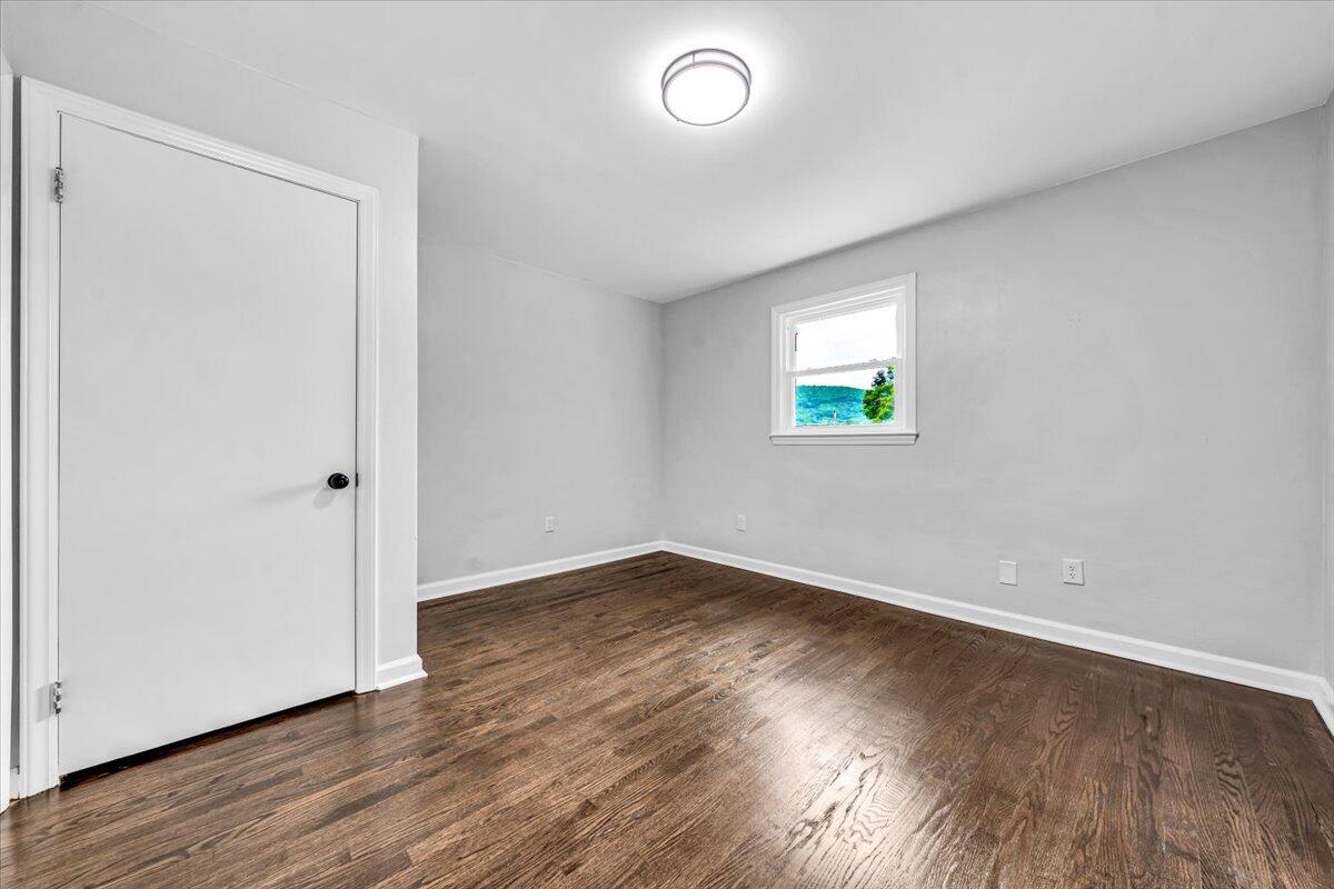 233 Oak Drive Blue Ridge, VA 24064 - Photo 16 of 37 an empty room with wooden floor and window