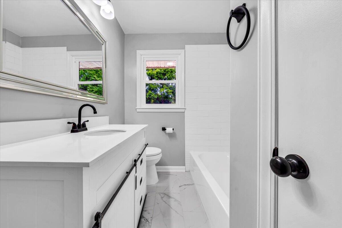 233 Oak Drive Blue Ridge, VA 24064 - Photo 21 of 37 a bathroom with a sink and a window