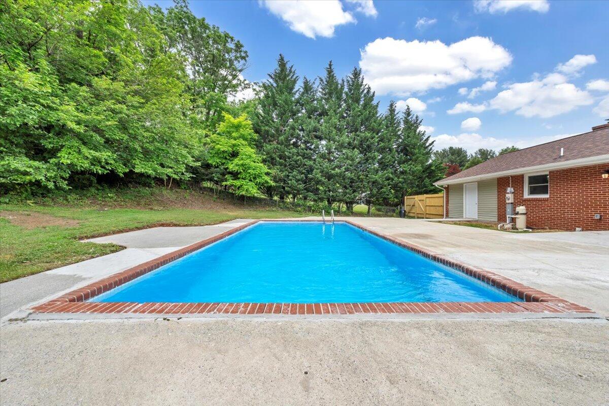 233 Oak Drive Blue Ridge, VA 24064 - Photo 26 of 37 a view of a house with pool and a yard