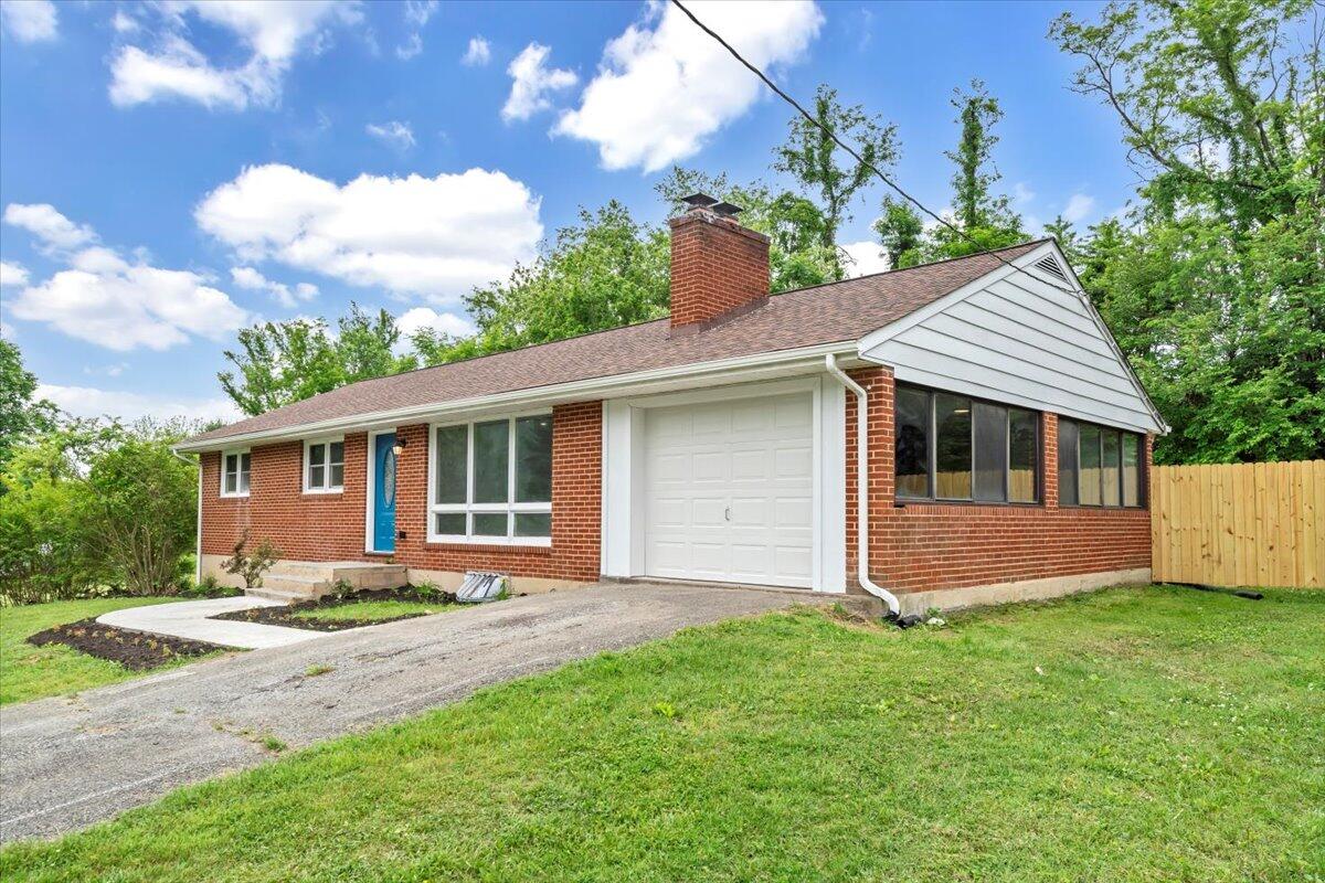 233 Oak Drive Blue Ridge, VA 24064 - Photo 36 of 37 a front view of a house with a garden and yard