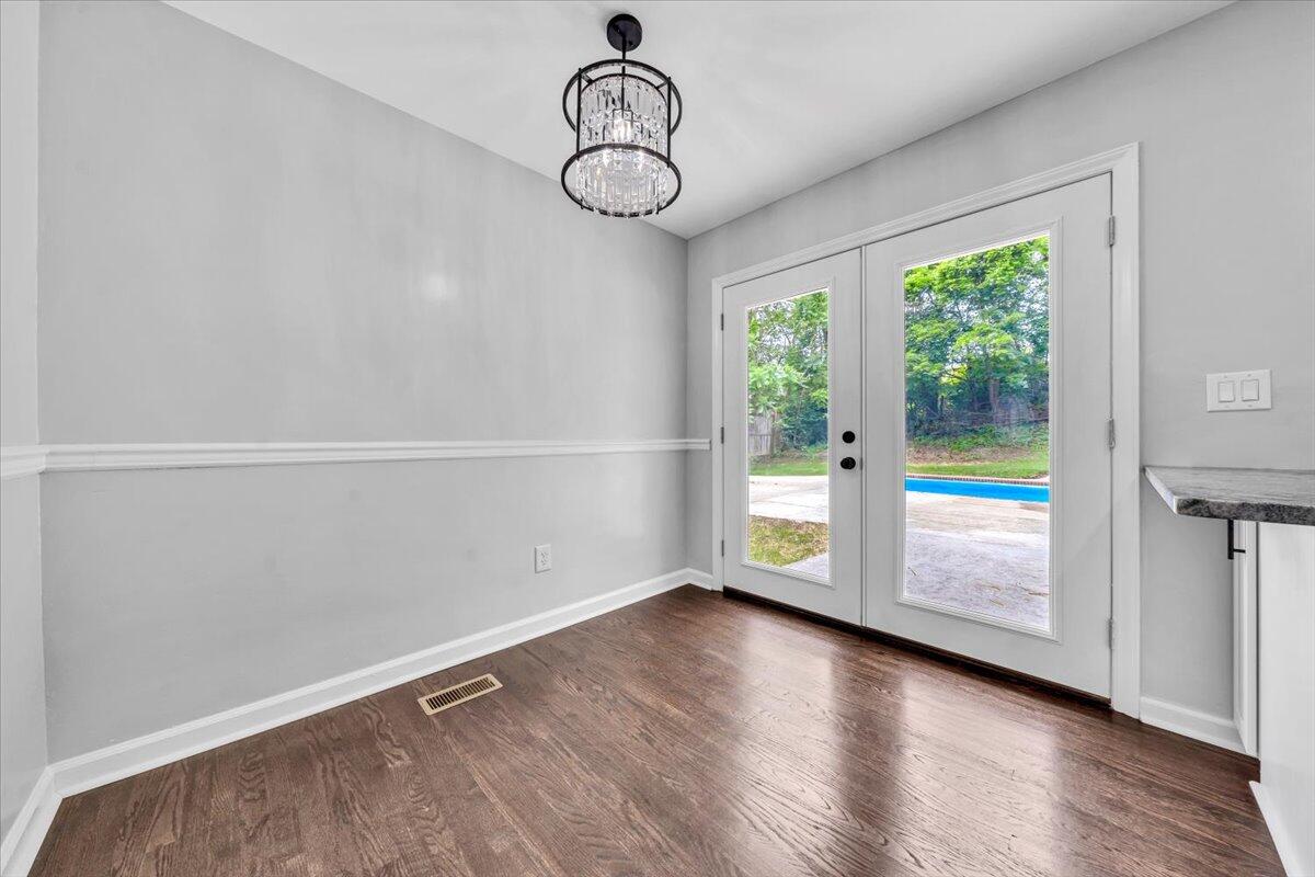 233 Oak Drive Blue Ridge, VA 24064 - Photo 6 of 37 a view of an empty room with window wooden floor and windows