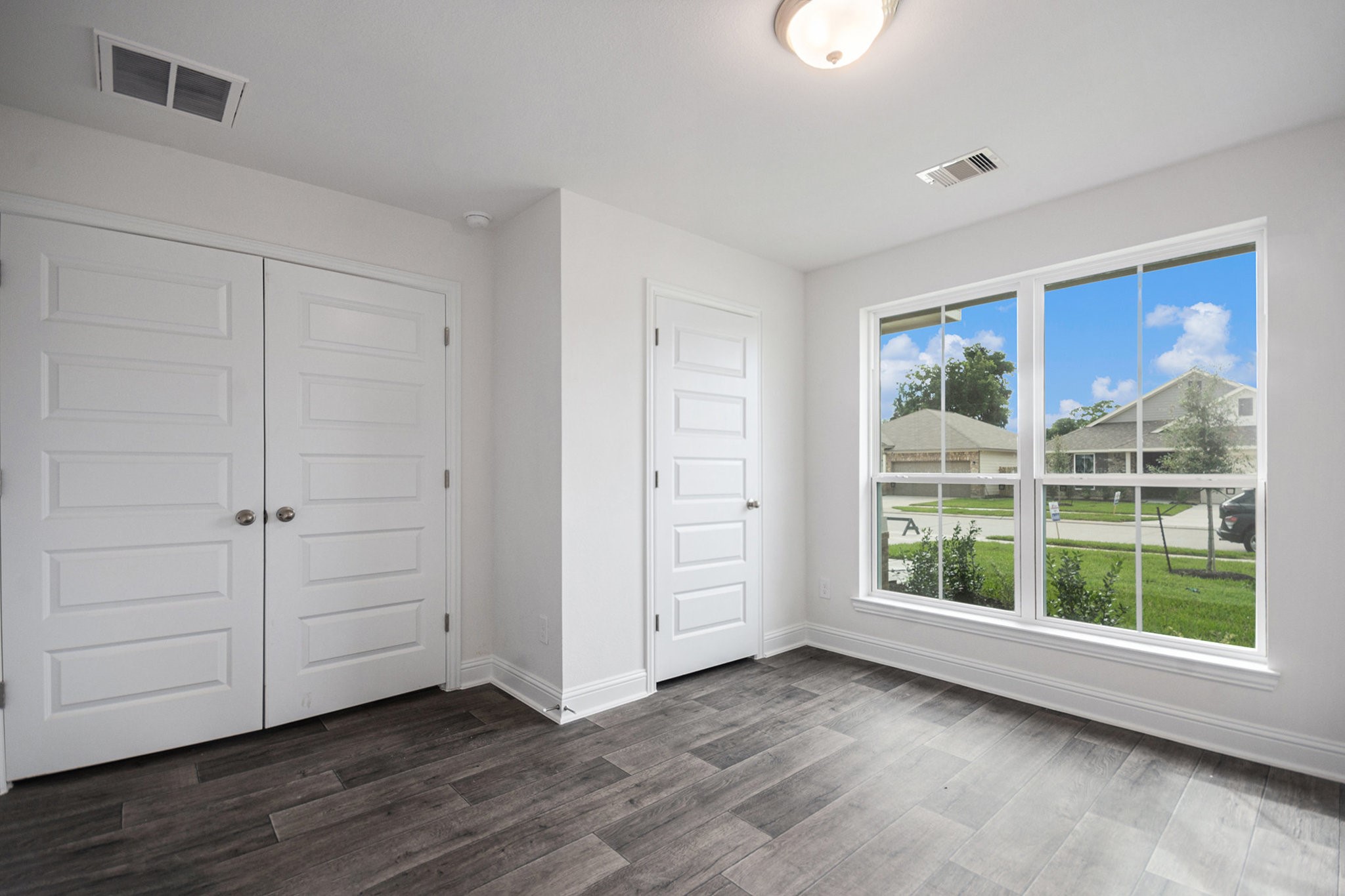 204 Bryan Way Angleton, TX 77515 - Photo 11 of 19 wooden floor in an empty room with a window