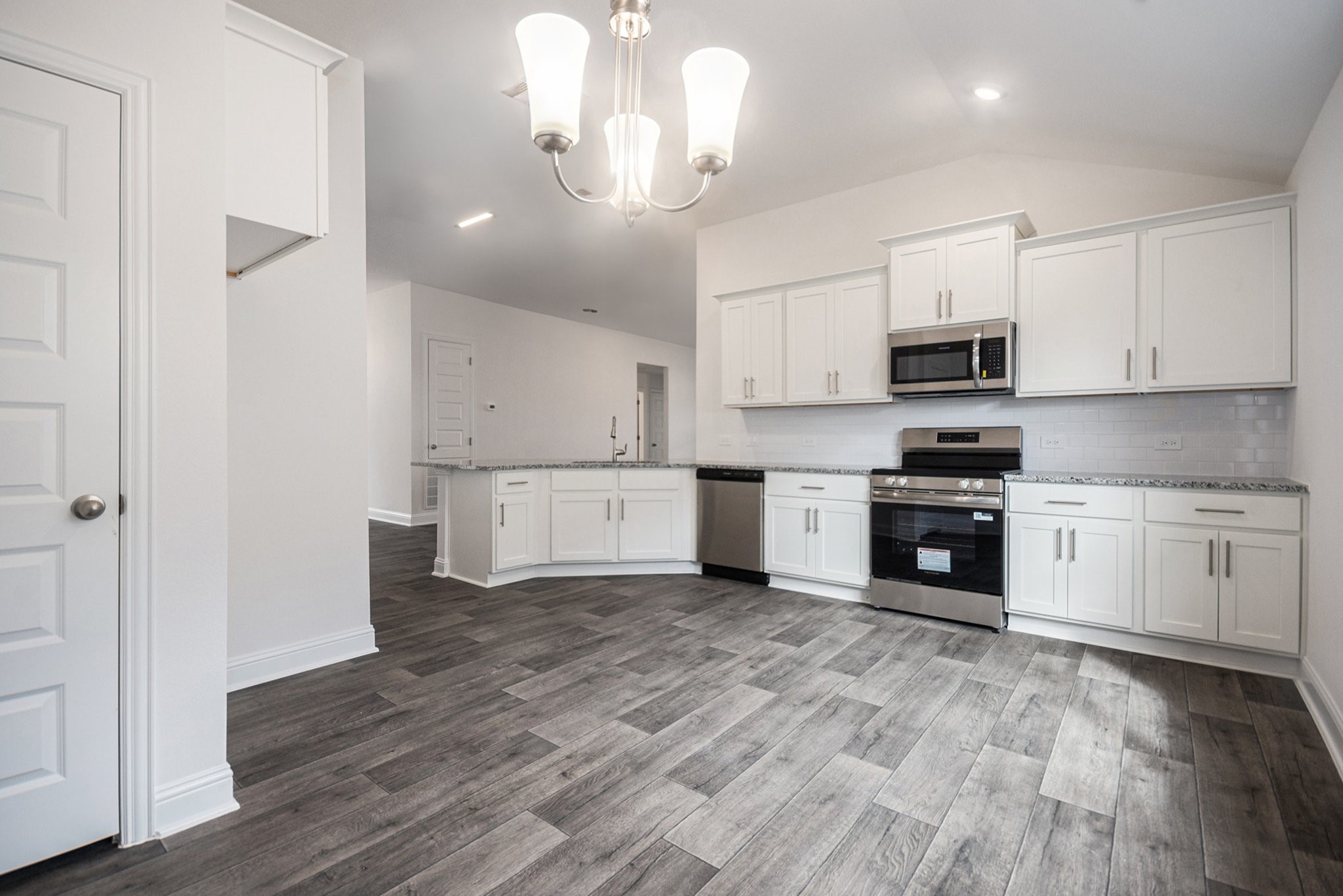 204 Bryan Way Angleton, TX 77515 - Photo 8 of 19 a kitchen with stainless steel appliances a white cabinets and wooden floor