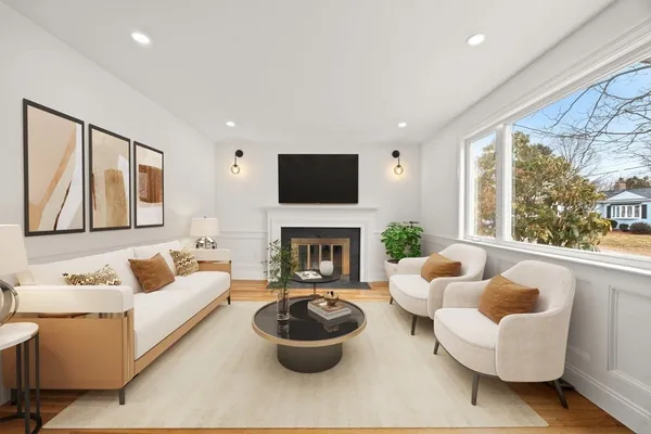 a living room with furniture a flat screen tv and a fireplace