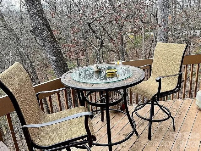 a view of a chairs and table in the balcony