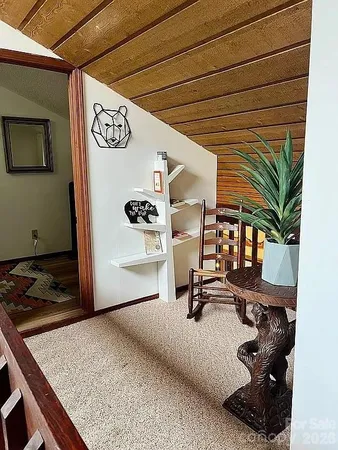 a view of a livingroom with furniture and floor to ceiling window