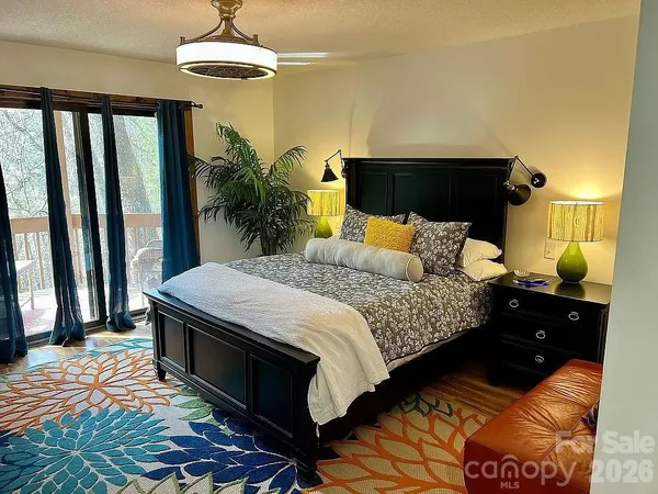 a bedroom with a bed and a chandelier