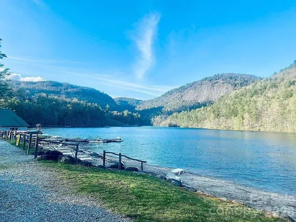 an aerial view of a house with a garden and lake view