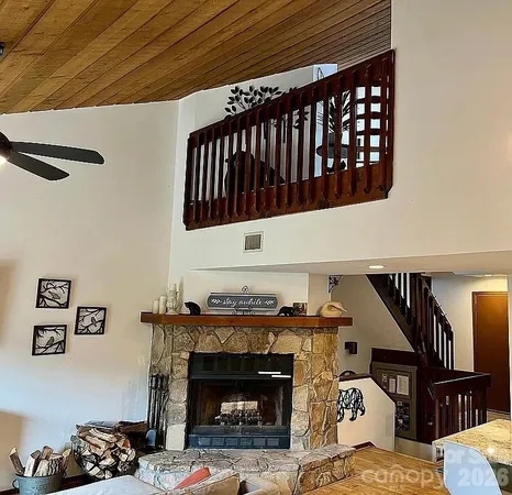 a living room with furniture a rug and a fireplace