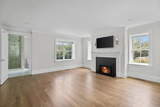 a view of empty room with a fireplace and a window