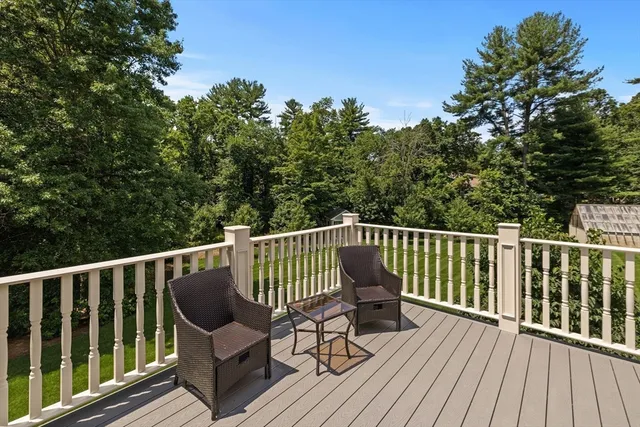 a view of balcony with wooden floor and outdoor seating