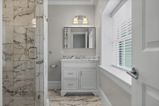 a bathroom with a sink a toilet and shower