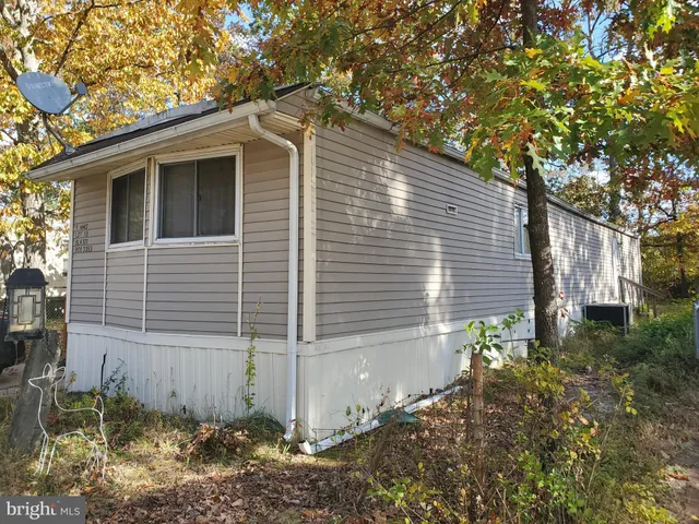 a side view of a house with a yard