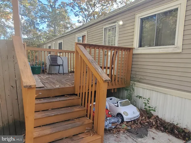 a view of entryway with wooden floor and seating space
