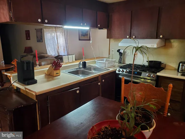 a kitchen with a sink a stove and cabinets