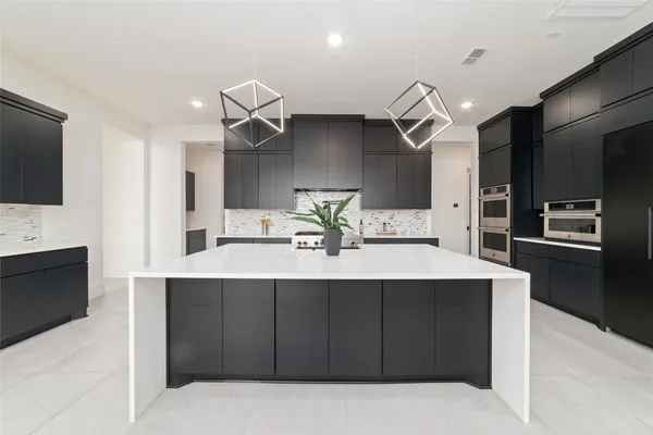 a kitchen with a sink stainless steel appliances and cabinets