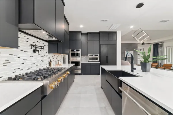 a kitchen with stainless steel appliances granite countertop counter space a sink and cabinets