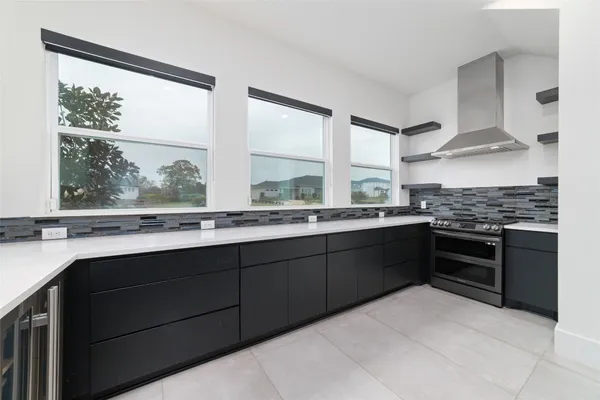 a kitchen with stainless steel appliances a sink window and cabinets