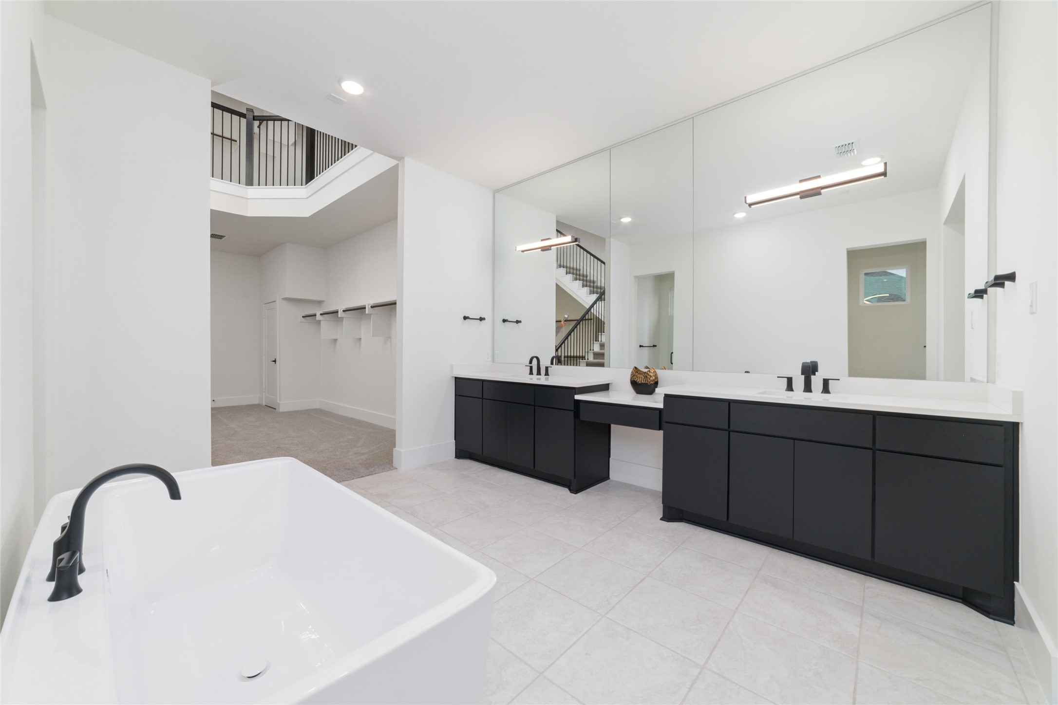 29627 Cir S Rnch Trail Fulshear, TX 77406 - Photo 24 of 50 a spacious bathroom with a double vanity sink and mirror