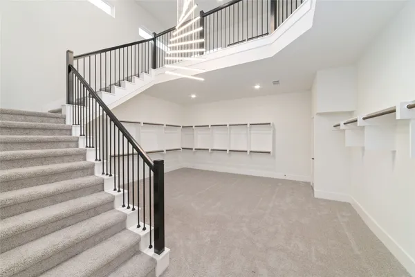 a view of staircase with white walls and a window