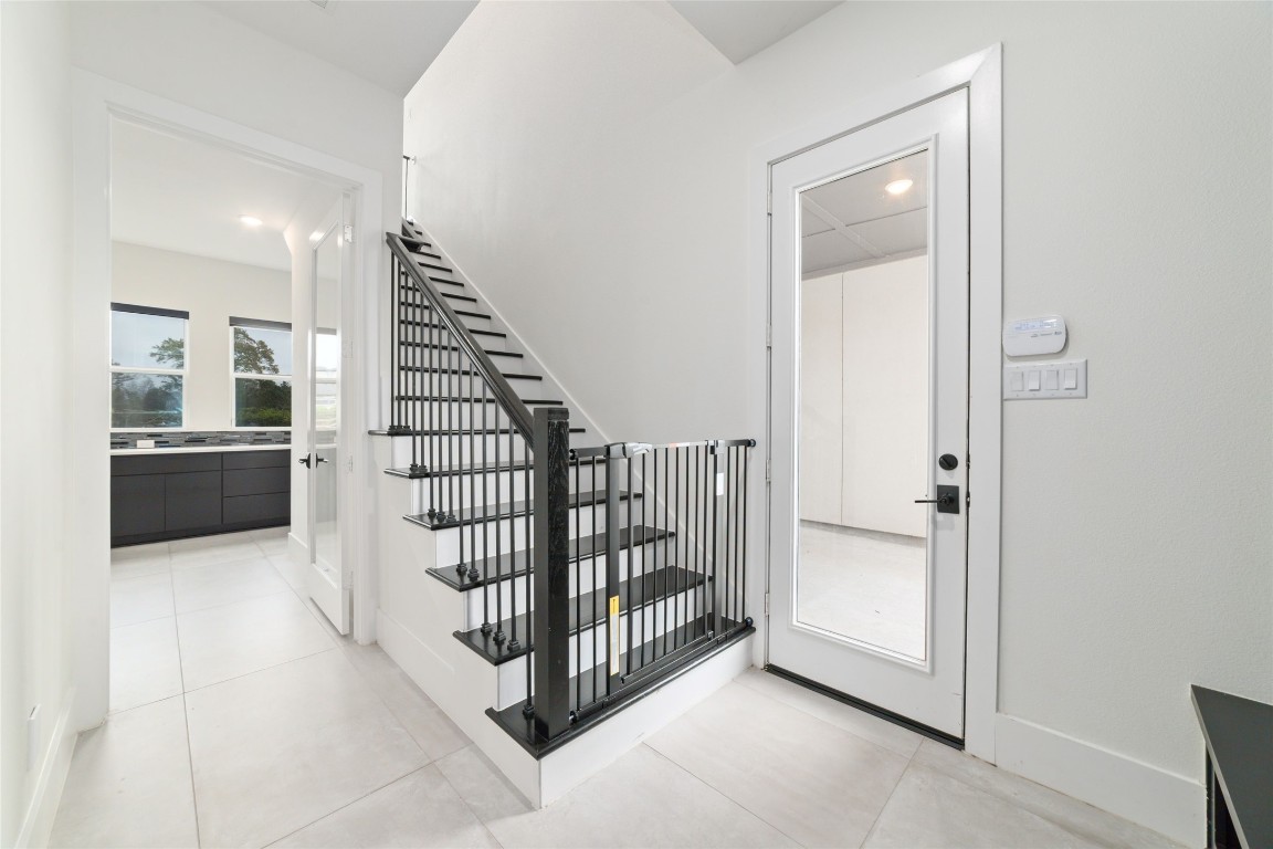 29627 Cir S Rnch Trail Fulshear, TX 77406 - Photo 33 of 50 Secondary staircase providing functional access while maintaining the home’s overall flow and privacy. Easy access to the motor court.