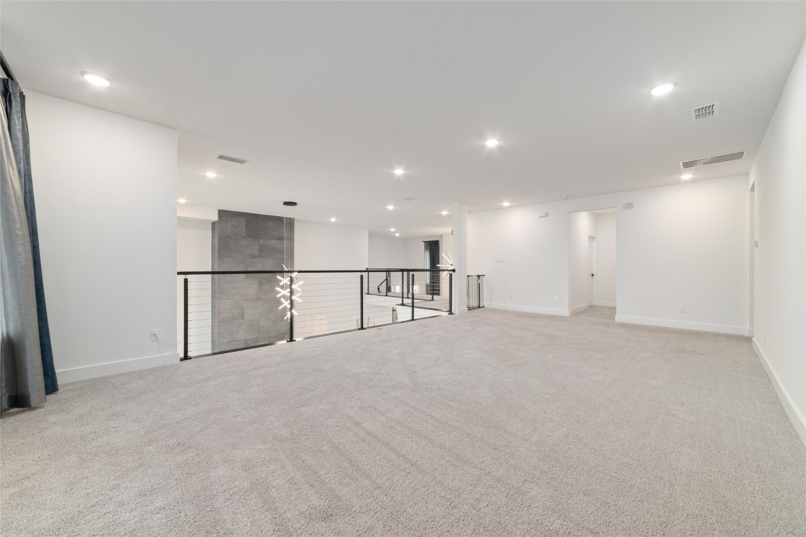 29627 Cir S Rnch Trail Fulshear, TX 77406 - Photo 36 of 50 Expansive upstairs game room with a loft-style overlook to the main living below, offering flexible space for lounge, media, or entertaining.
