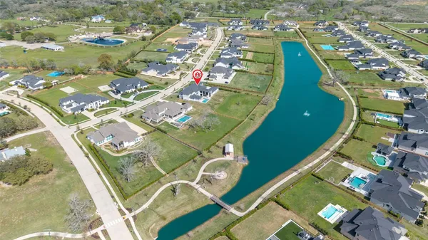 an aerial view of a residential houses with outdoor space