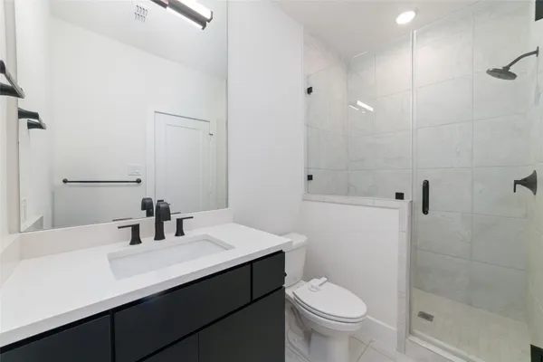 a bathroom with a sink toilet and shower