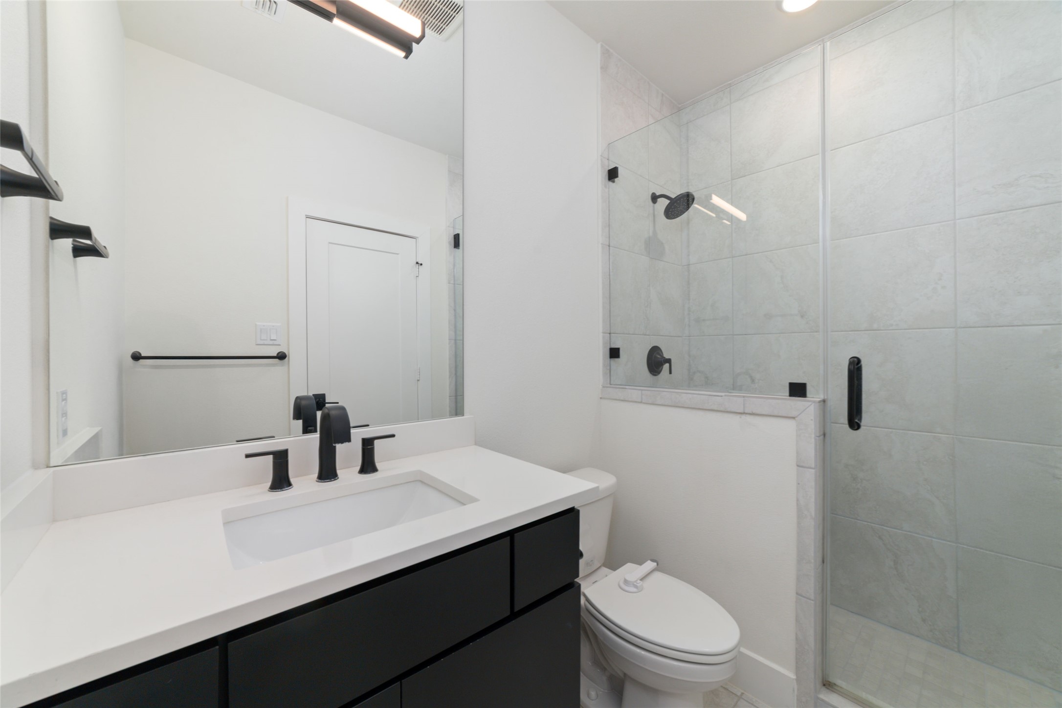 29627 Cir S Rnch Trail Fulshear, TX 77406 - Photo 43 of 50 a bathroom with a sink a toilet a shower and a mirror
