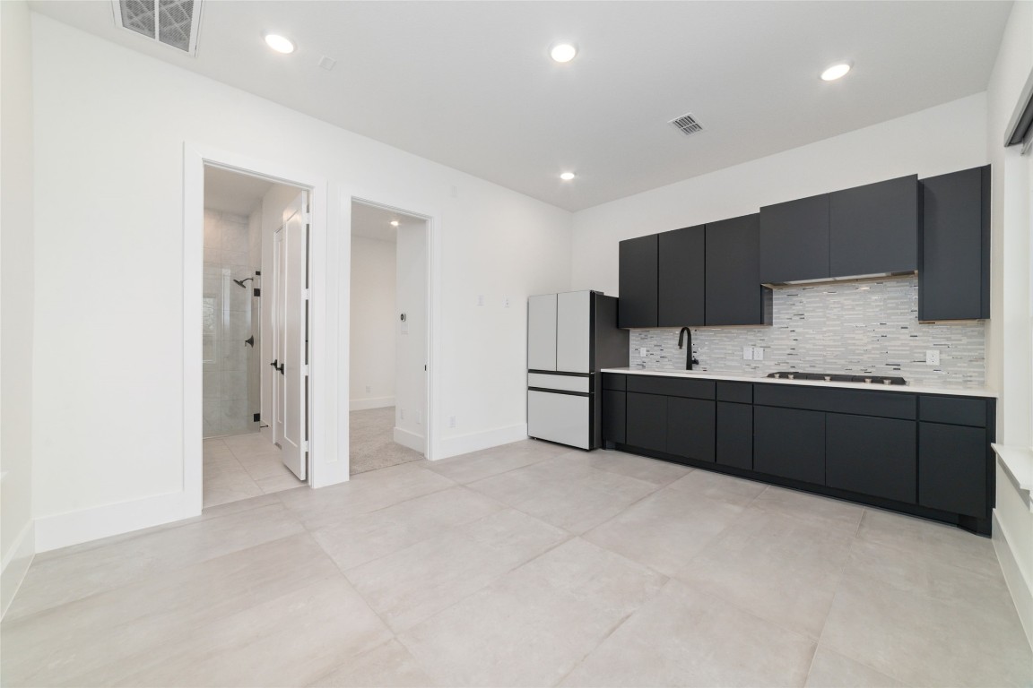 29627 Cir S Rnch Trail Fulshear, TX 77406 - Photo 46 of 50 First-floor casita with private entry, designed for true independence, complete with living room, full kitchen with full-size appliances, bedroom, and bath, and direct access to the motor court, pool, spa, and covered patio.