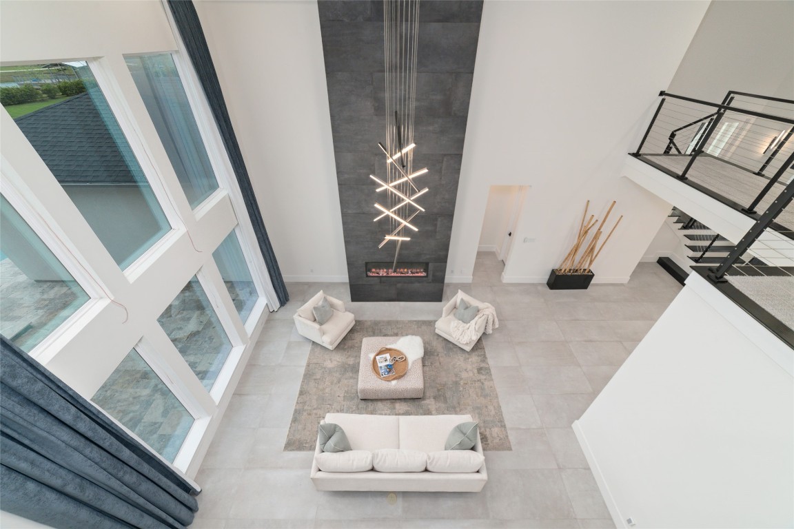 29627 Cir S Rnch Trail Fulshear, TX 77406 - Photo 10 of 50 Two-story living with vertical volume and a fireplace wall that anchors the entire space.