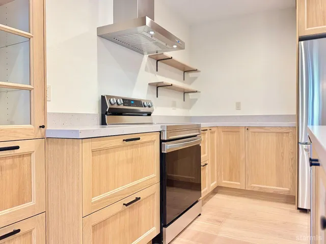 a kitchen with stainless steel appliances granite countertop a stove and a refrigerator