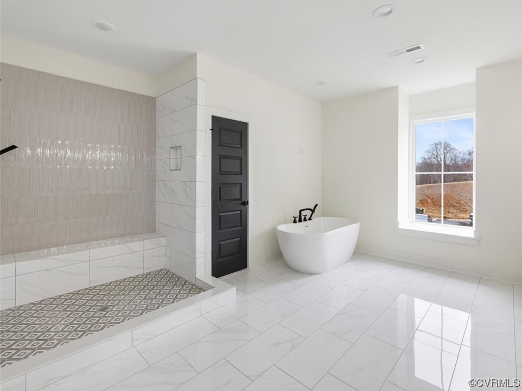 10712 River Fall Path Glen Allen, VA 23059 - Photo 18 of 28 a bathroom with a bathtub and shower