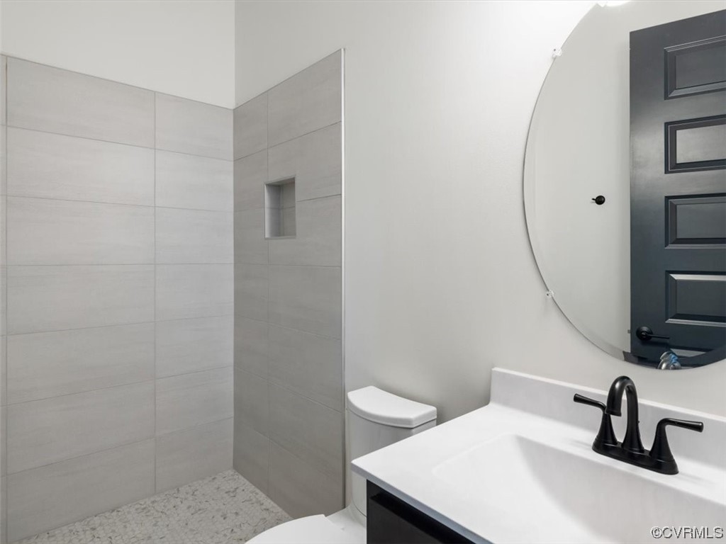 10712 River Fall Path Glen Allen, VA 23059 - Photo 6 of 28 a bathroom with a sink a toilet and a mirror
