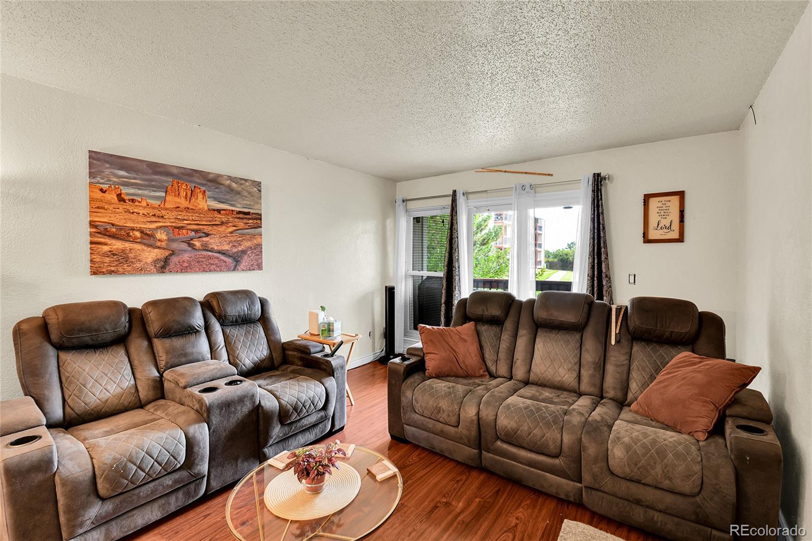 8470 Decatur Street, Unit 80 Westminster, CO 80031 - Photo 12 of 28 a living room with furniture a couch and a window